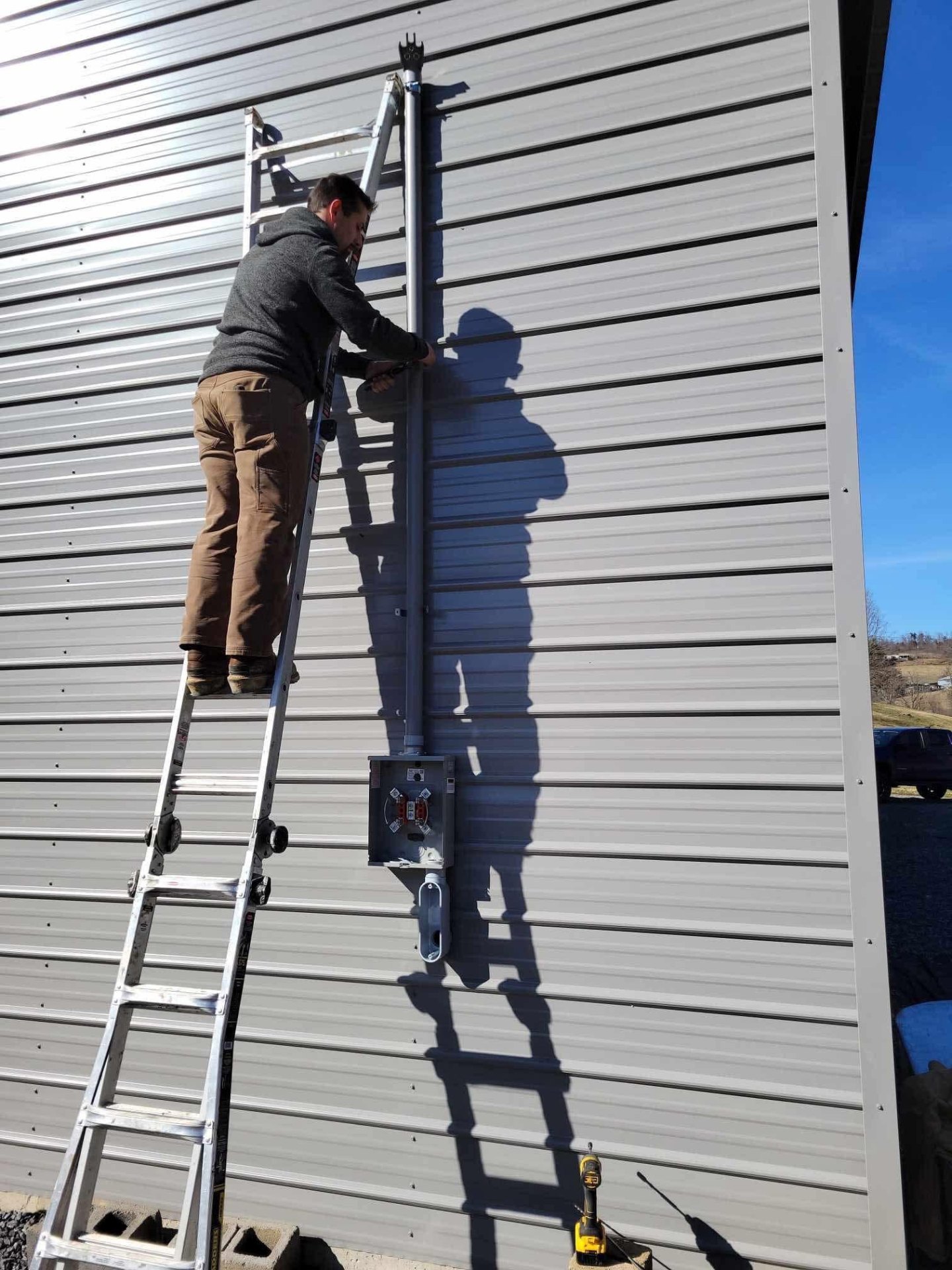 Service mast riser and meter base installed on a metal pole barn in Hawkins County TN